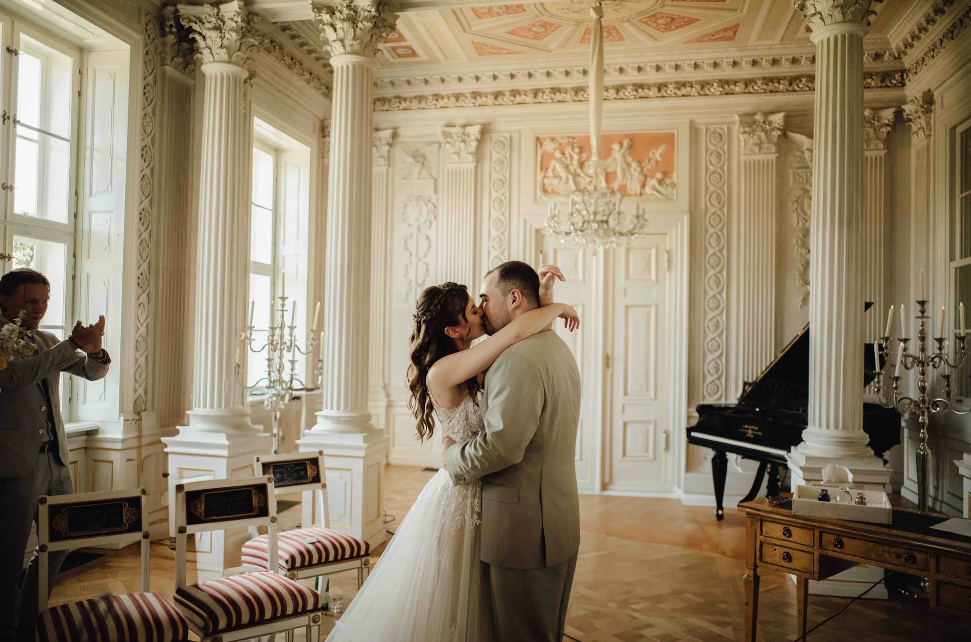 Intimate kiss between a wedding couple in classical architecture